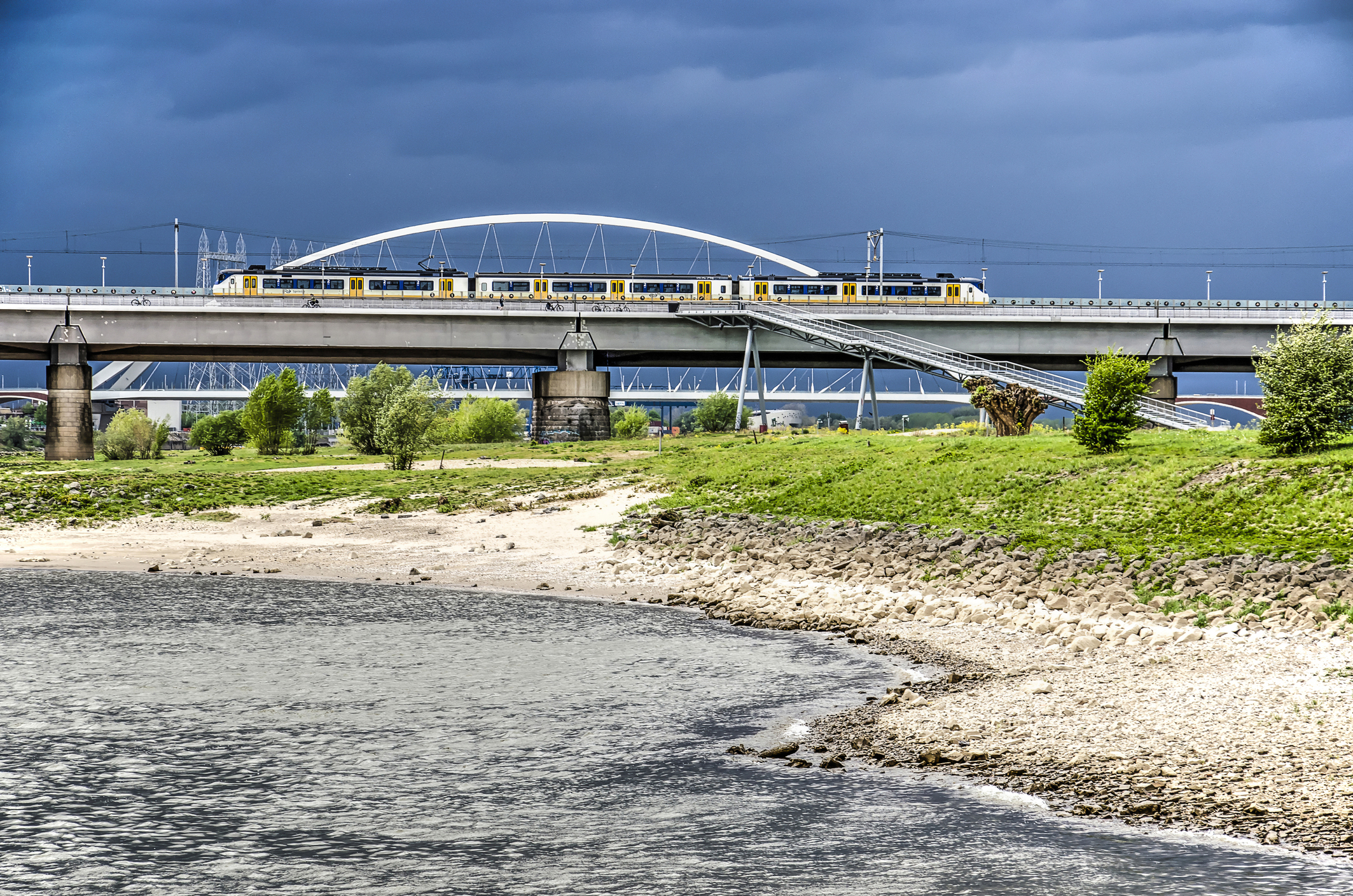 Bridges and beach under a dark sky Railway Bridge